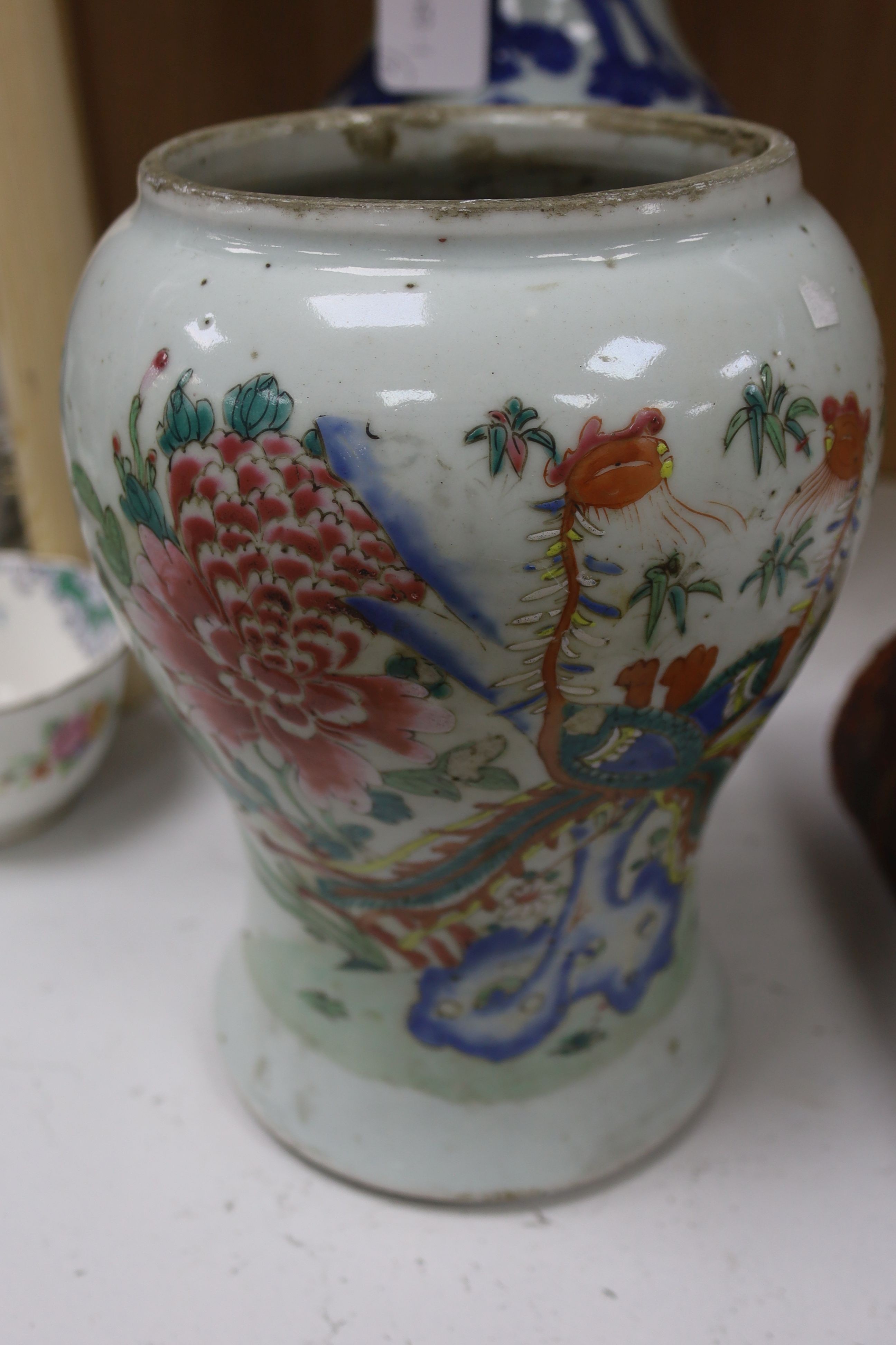 A Chinese blue and white 'Immortals' vase, 18th/19th century, damage, 34.5cm and a Chinese Yongzheng period famille rose ‘phoenix’ vase (reduced in height), 24cm